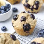 Healthy blueberry banana muffins on a cooling rack.