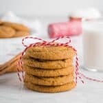 A stack of 40 ginger cookies with cinnamon sticks and milk.