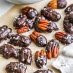 A bowl of chocolate covered pecans, a delicious and healthy snack option, adorns a table.