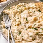 Cheesy gluten-free pasta dip in a bowl with a fork.