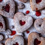 40 heart-shaped gluten-free cookies covered in powdered sugar.