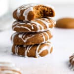 A stack of gluten-free ginger cookies with icing on top.