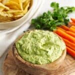 Healthy snack recipe: A bowl of guacamole with carrots and chips.