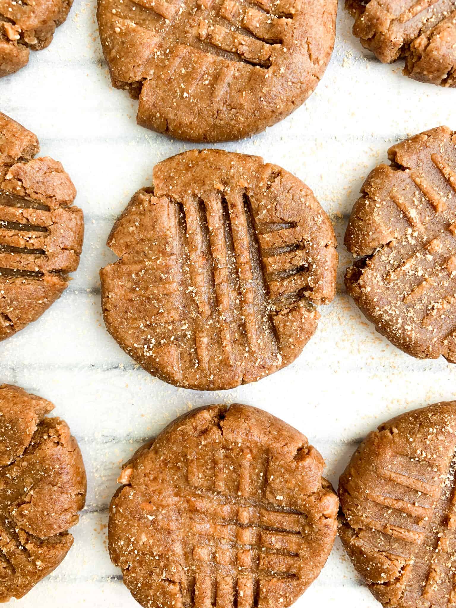 Easy gluten-free peanut butter cookies on a white surface.