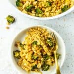 A bowl of gluten-free pasta with broccoli and chickpeas.