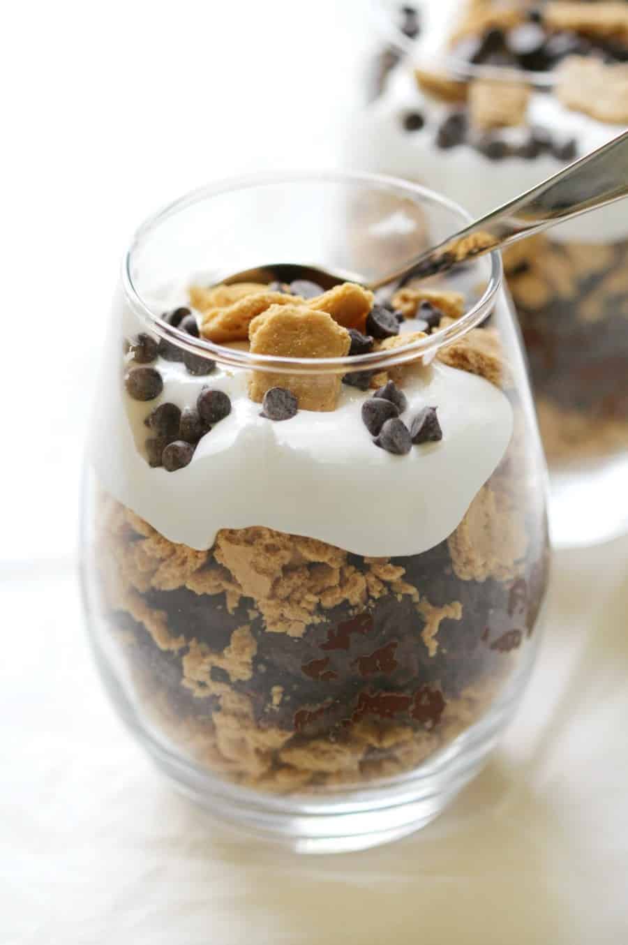 Easy gluten free chocolate granola parfait with whipped cream and chocolate chips.