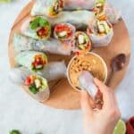 46 Vietnamese spring rolls served on a wooden plate.