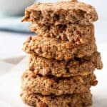 A stack of 40 gluten-free oatmeal cookies on a white plate.