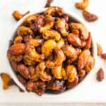 Delicious roasted cashews in a white bowl, a healthy snack option.