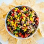 A bowl of gluten-free black-eyed-pea salsa with tortilla chips.