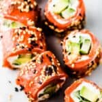 Gluten-free salmon sushi rolls with cucumber and sesame seeds, 
the perfect appetizer for any occasion.