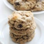 A stack of 40 oatmeal chocolate chip cookies, all gluten-free, beautifully arranged on a plate.