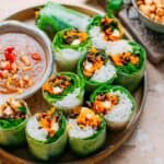 Thai spring rolls with peanut sauce on a plate, perfect for gluten-free appetizers.