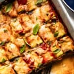 Zucchini lasagna, one of the 50 easy gluten-free dinners, is served in a baking dish and enjoyed with a fork.