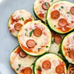 Healthy zucchini pizza bites arranged on a plate.
