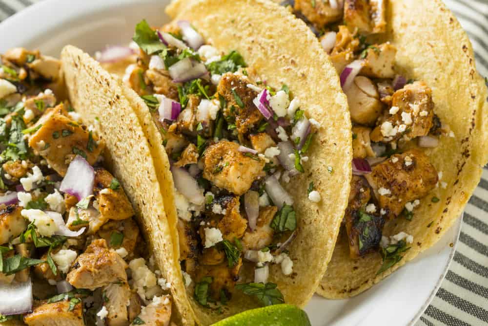 Homemade Chicken Tacos with Onion Cilantro and Cheese