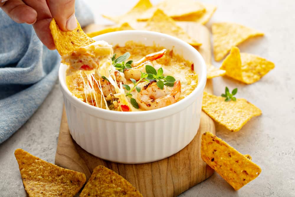 Spicy seafood dip in a ramekin with corn chips