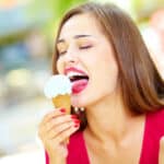Close-up of a pretty girl enjoying an ice-cream cone