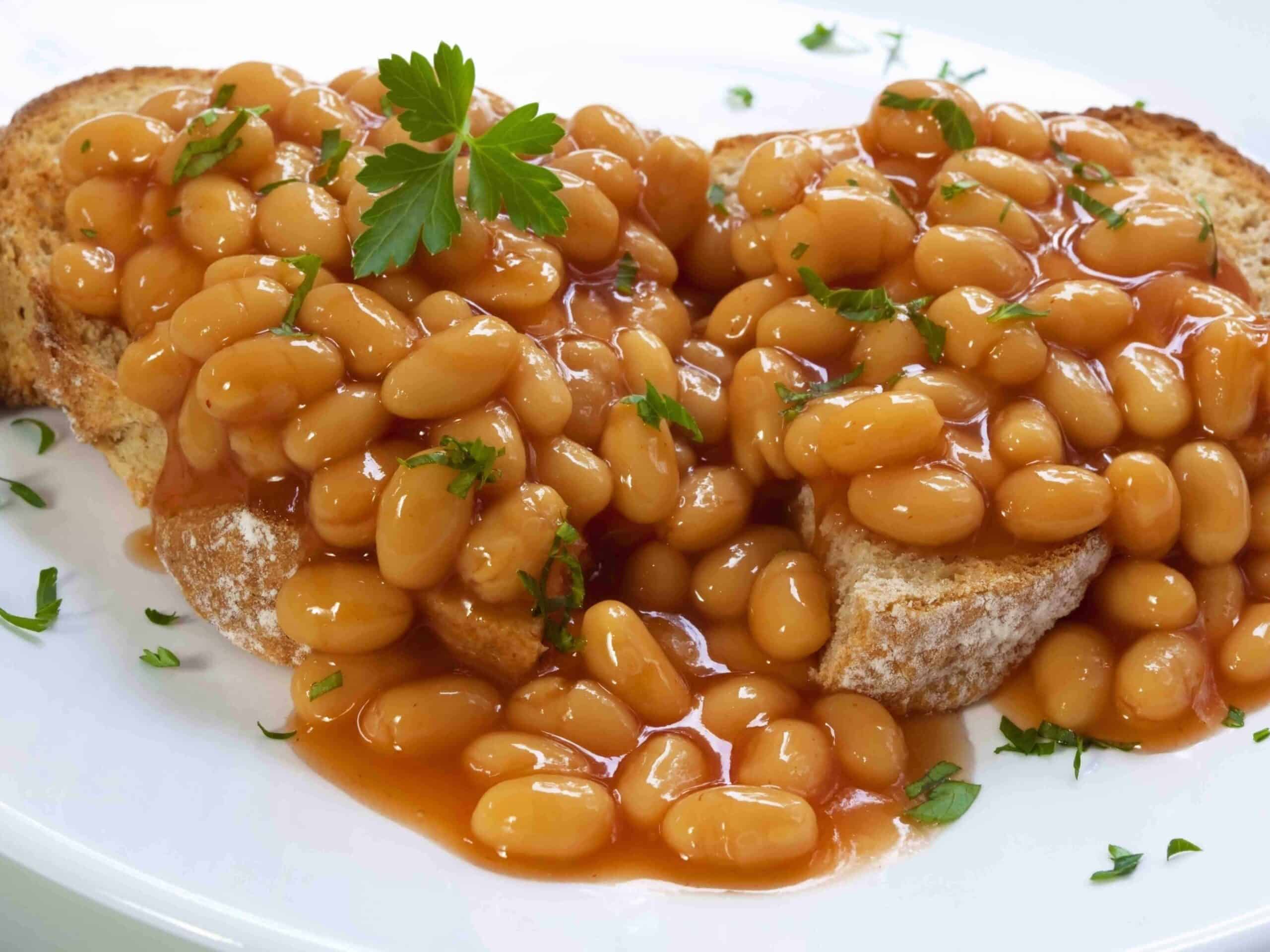 Baked beans on sourdough toast, garnished with parsley.