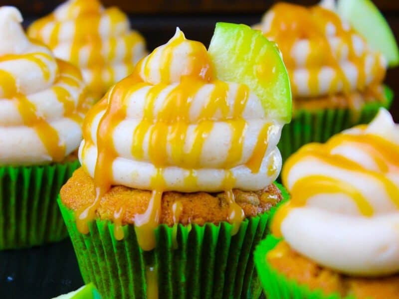 Caramel cupcakes in green paper wrappers.