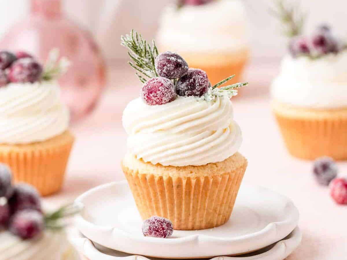 Cranberry cupcakes with frosted cranberries on top.
