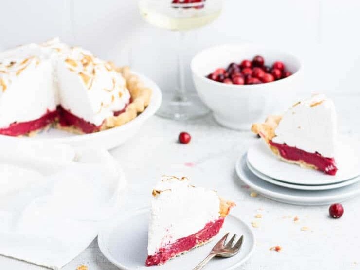 Cranberry pie with two slices on white plates. 