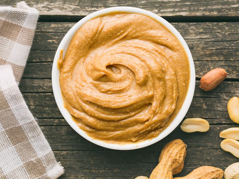 Creamy peanut butter and peanuts. Spreads peanut butter in the bowl.