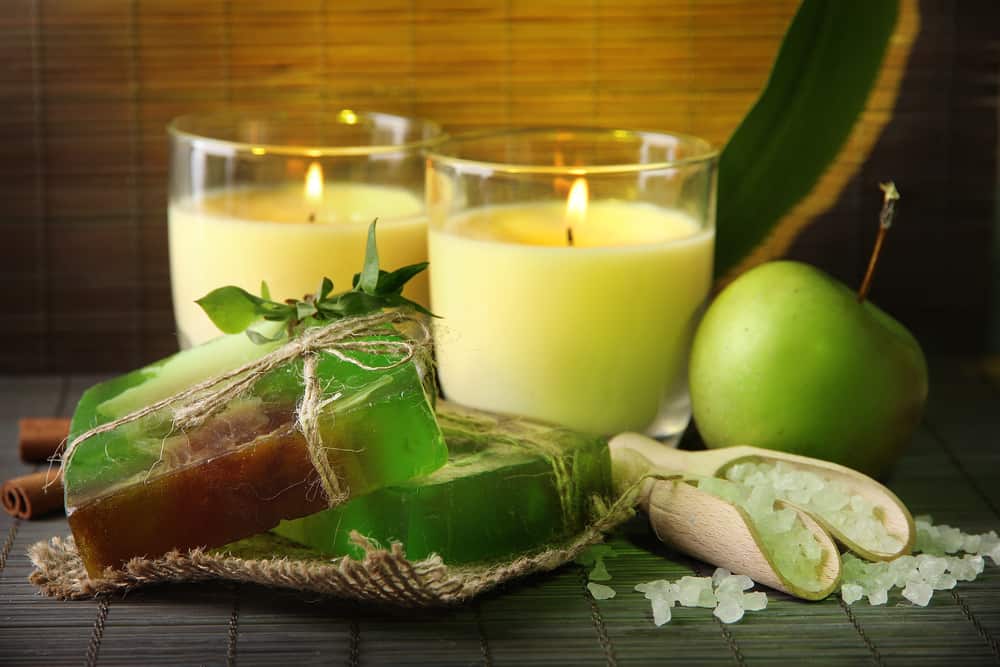 Hand made soap and candles on bamboo mat background