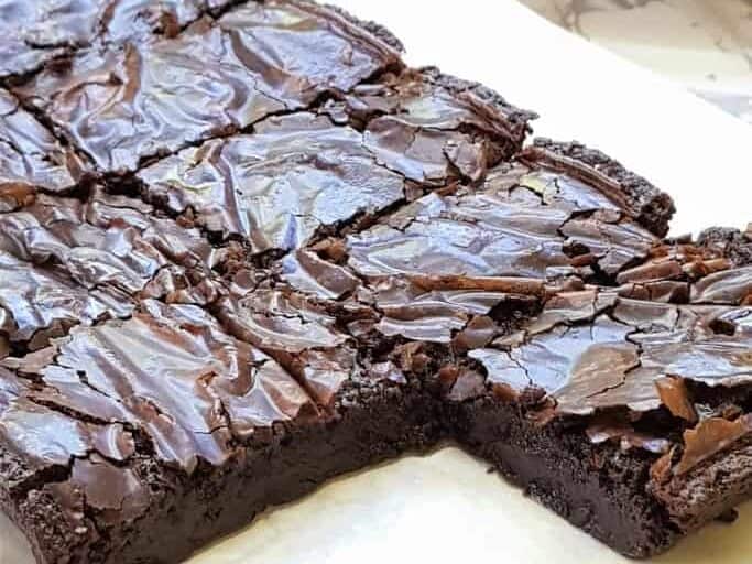 Fudgy brownies with two slices out.