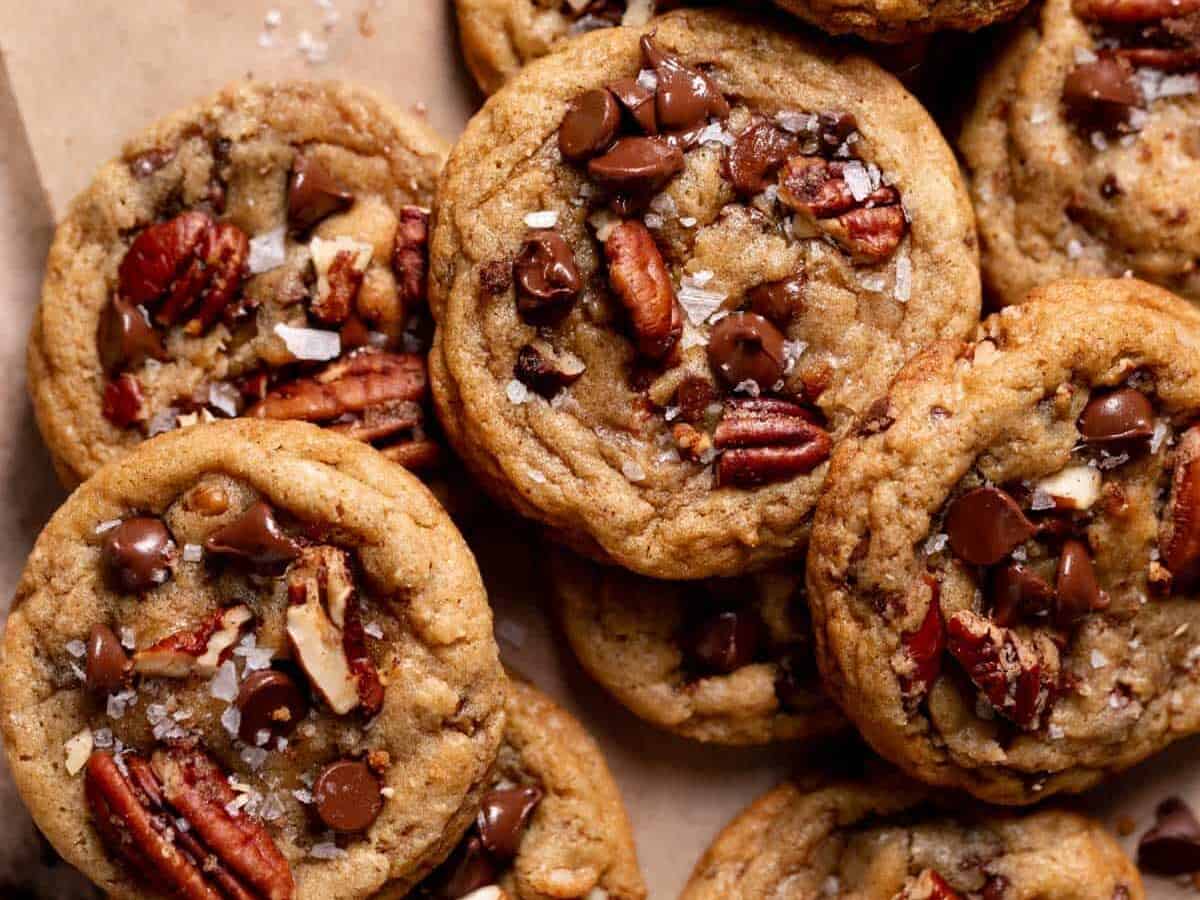Chocolate chip cookies with pecans on top.