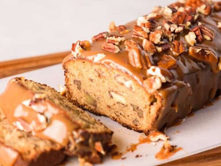 Pecan Pound Cake sliced on a wooden board.