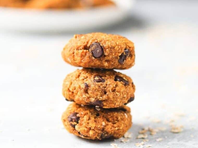 Three pumpkin cookies stacked up.