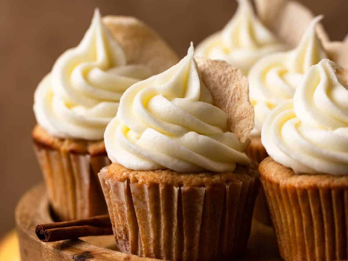 Apple cupcakes with tall frosting.