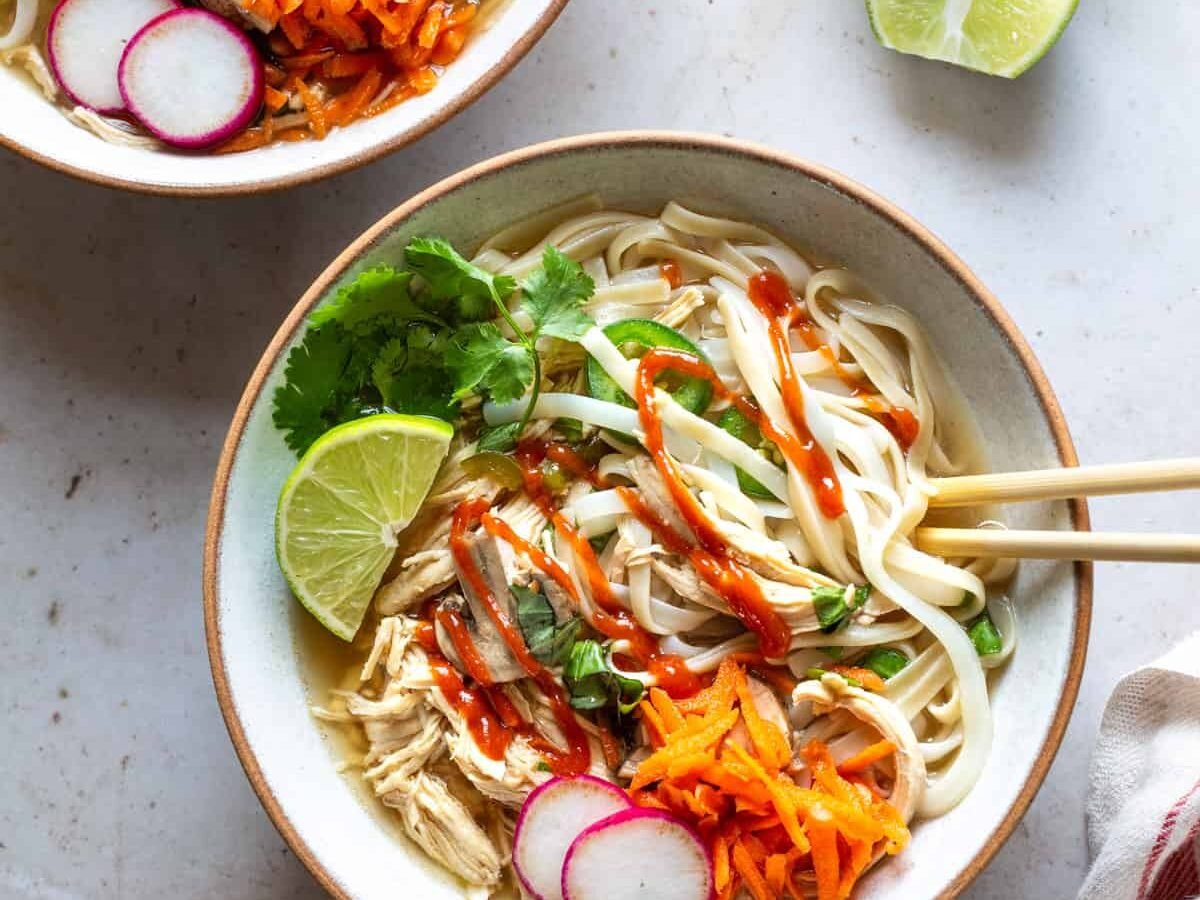 Chicken pho with sriracha sauce.