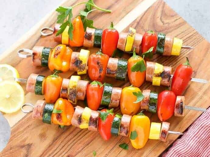 Chicken Sausage Skewers with Vegetables on skewers on a cutting board