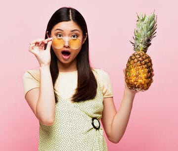 woman eating pineapple