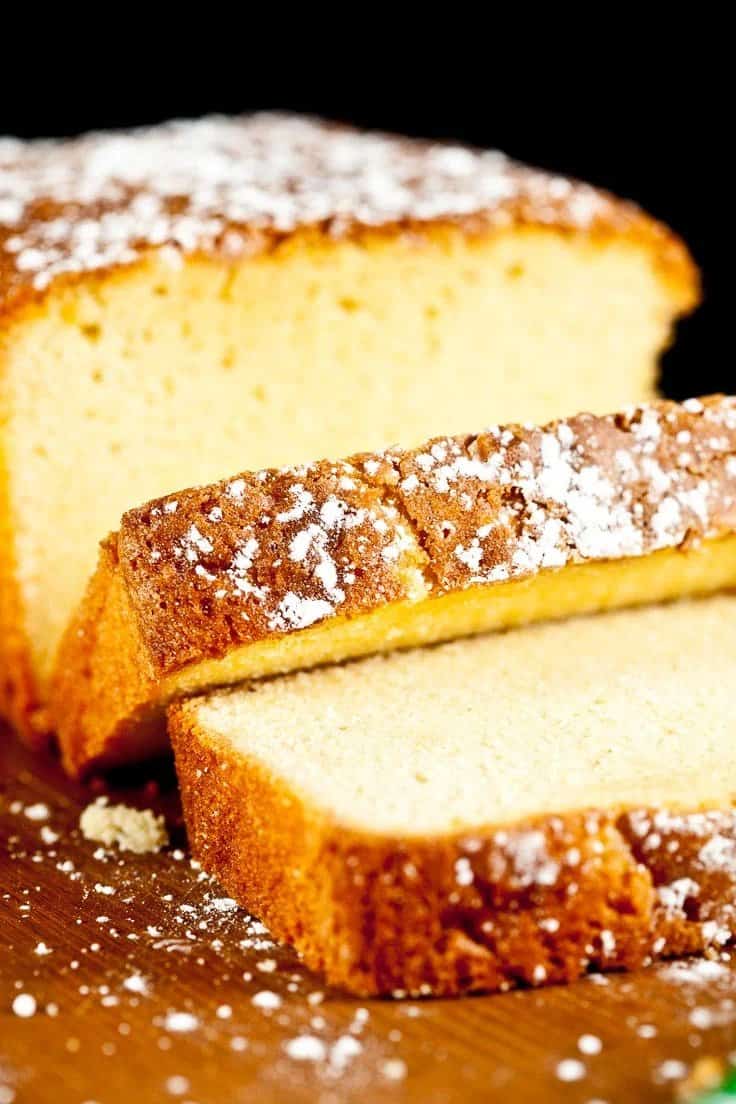 An American slice of lemon pound cake with powdered sugar.