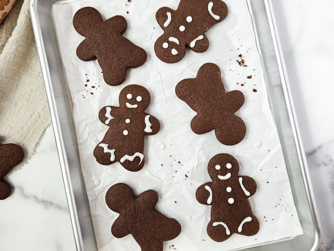 Chocolate gingerbread cookies on a baking sheet.