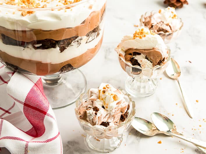 A chocolate trifle with whipped cream and sprinkles.