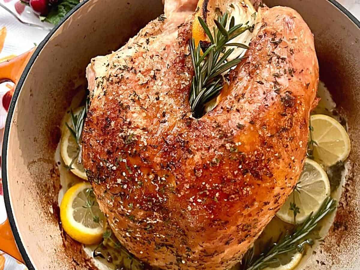 Oven roasted turkey breast in a Dutch oven with lemon and rosemary. 