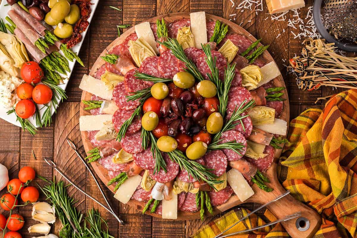 Italian Antipasto Board Appetizer with cold cuts, cheeses, and fruits.