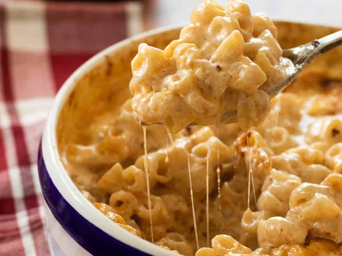 Close-up shot of a scoop of cheesy Mac & Cheese.
