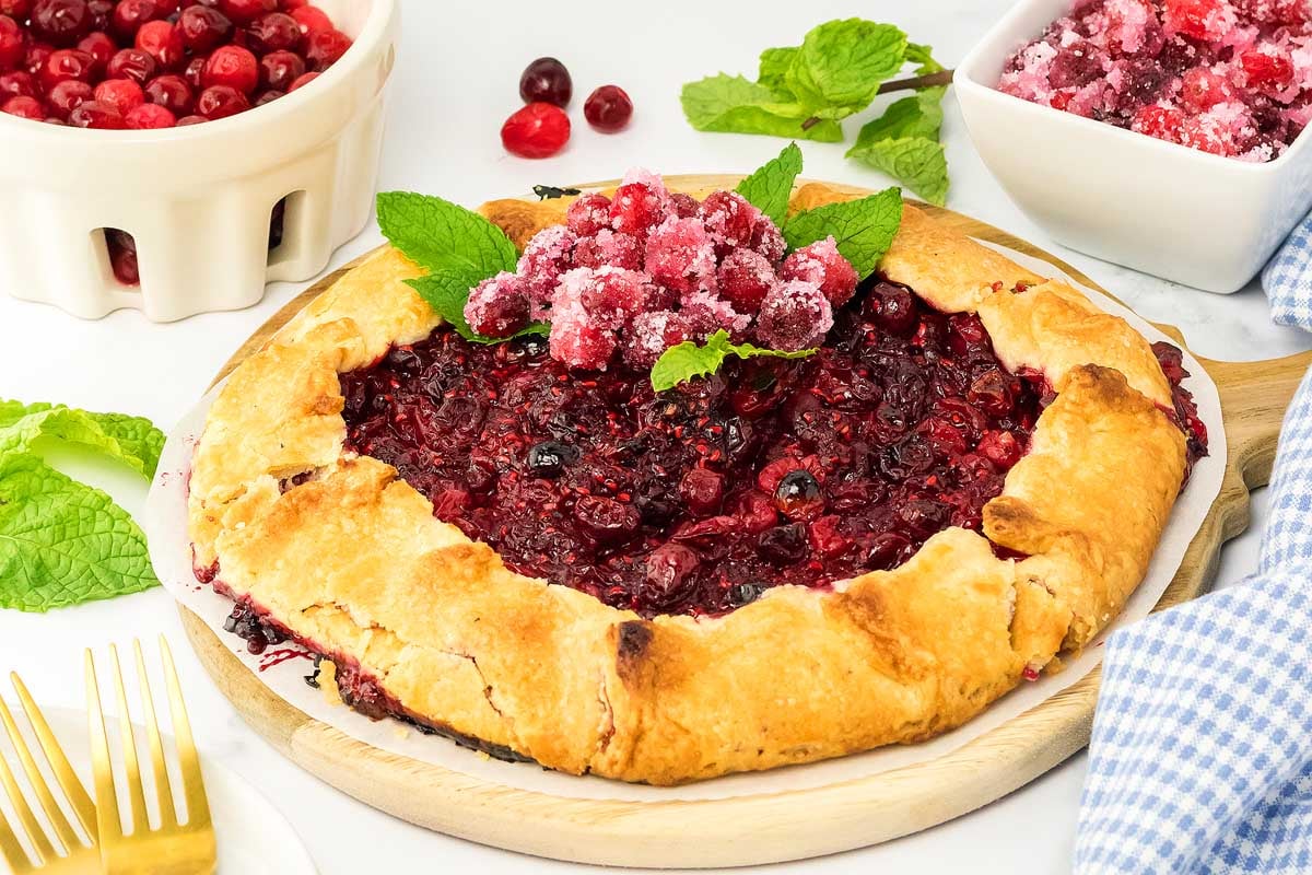 A heart shaped cranberry tart, perfect for Christmas desserts, on a plate.