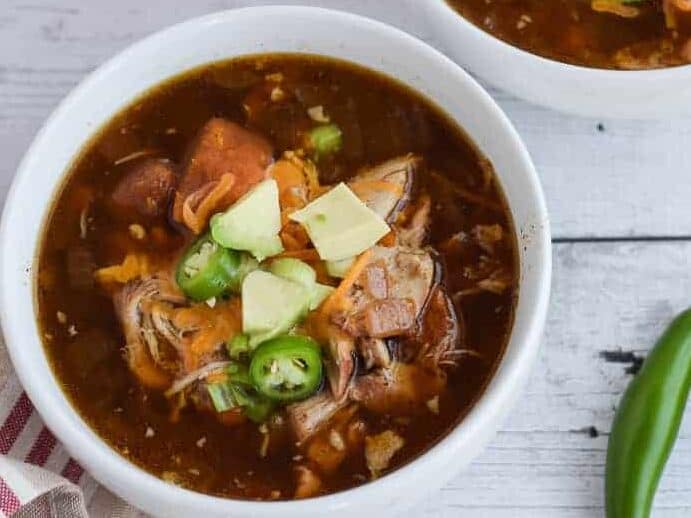 Slow cooker Mexican chicken soup in a white bowl.