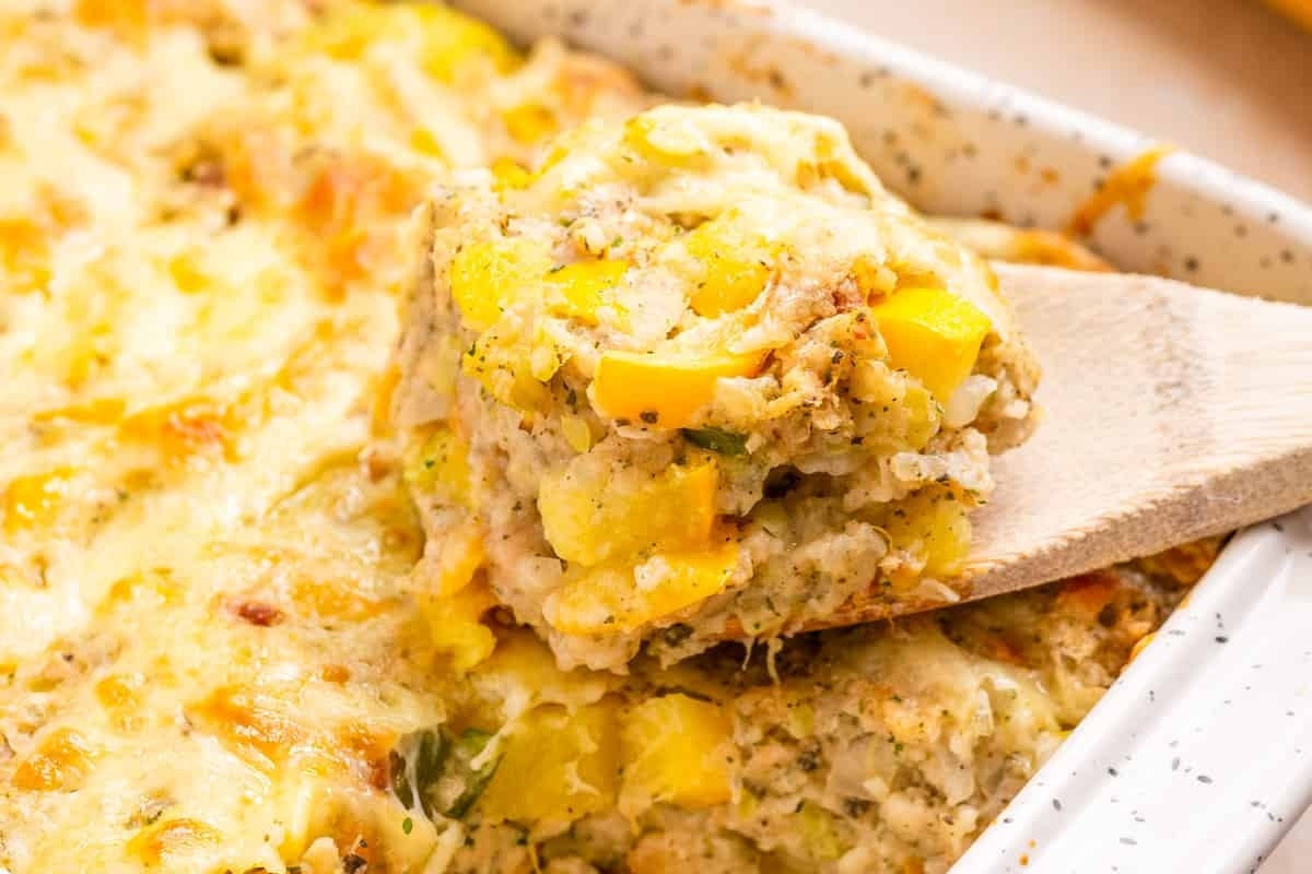 A spoonful of Squash Casserole with Stuffing in close-up.