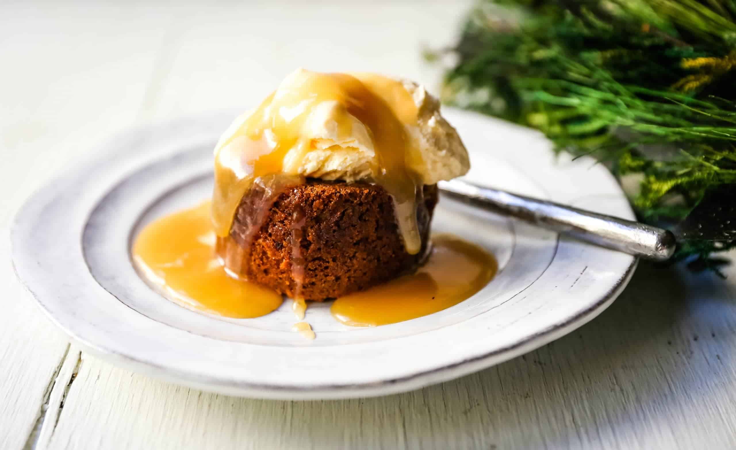 A festive Christmas dessert consisting of a delectable cake adorned with a generous scoop of creamy ice cream and drizzled with decadent caramel sauce.