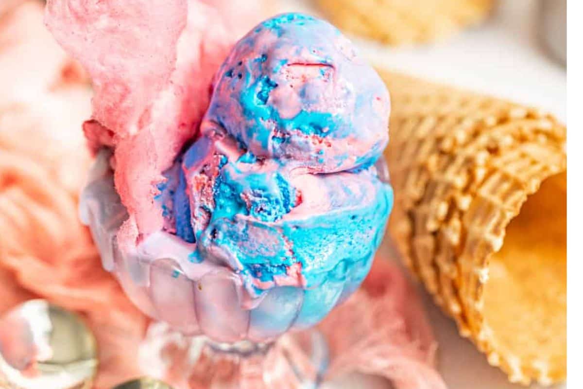 A dish of pink and blue cotton candy ice cream.