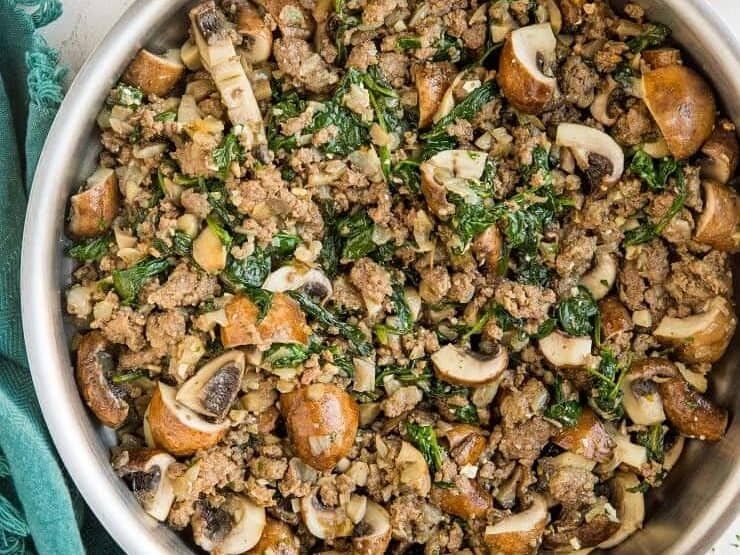Ground beef and mushrooms in a skillet.