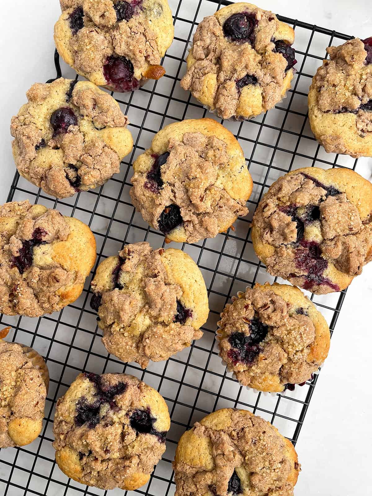 Blueberry Cobbler Gluten-Free Muffins on a cooling rack.