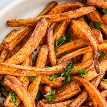 Gluten-free and dairy-free sweet potato fries served in a white bowl.